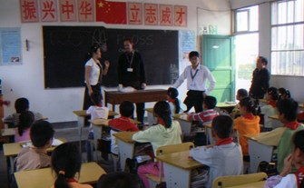Dr. Cooper explaining the importance of oral health and healthy eating to a Chinese class.