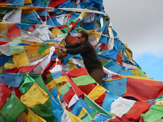 Dr. Cooper affixing the Bemidji Orthodontics flag to the rest of the national flags at the Mt. Everest ground base.